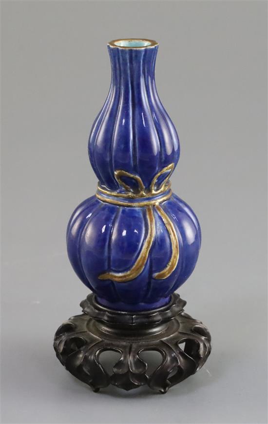 A small Chinese blue glazed double gourd vase, 18th/19th century, H. 10.7cm, good carved wood stand,